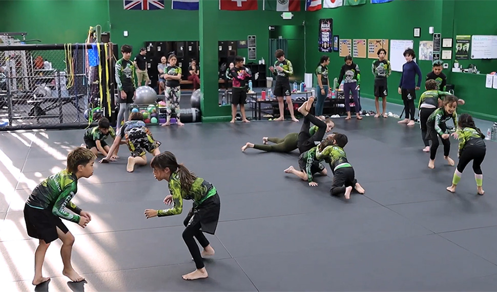 Young students learning techniques in the Kids Class at 10th Planet Pasadena